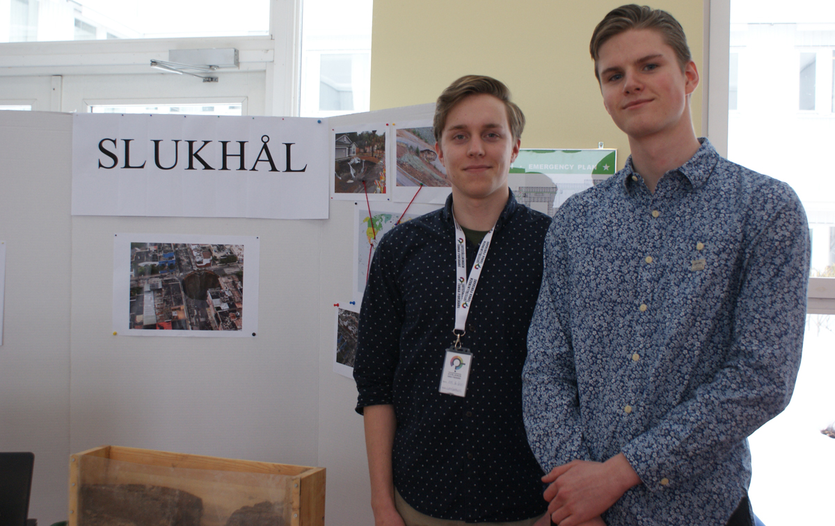 Two male pupils at their exhibition stand