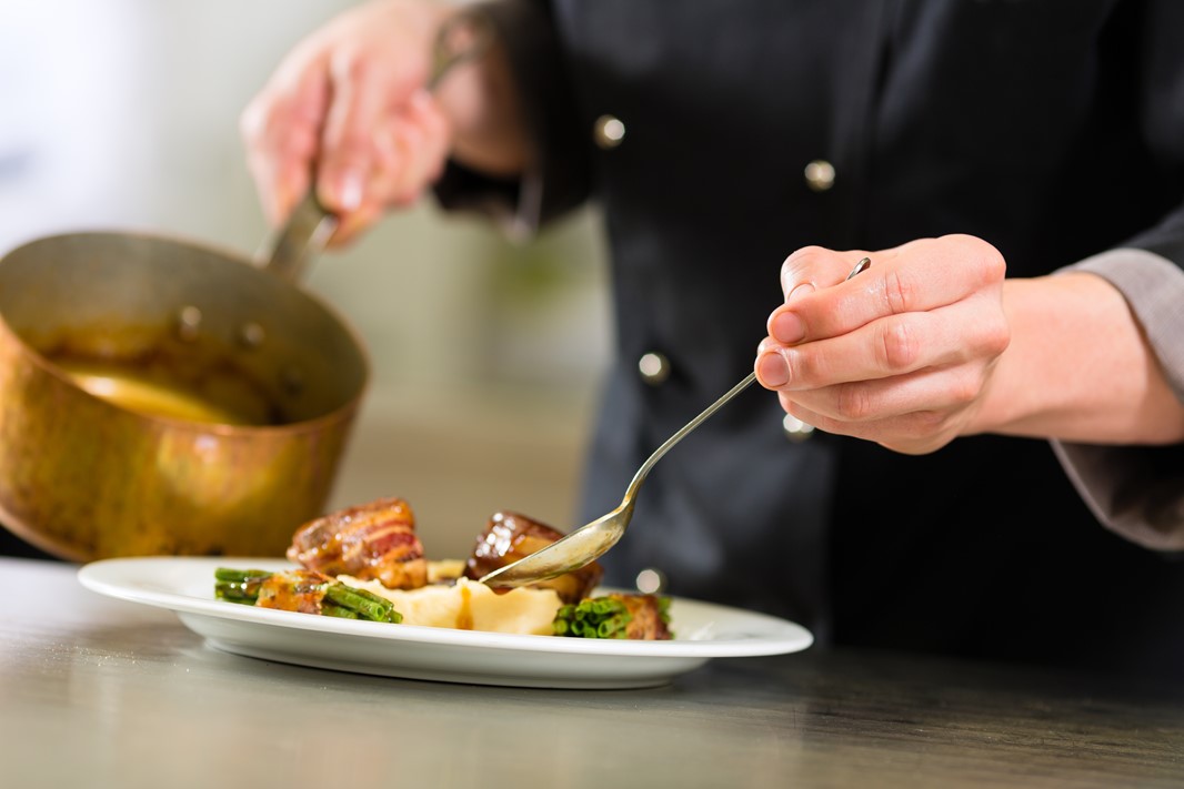 Chef in kitchen preparing food