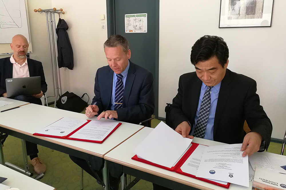 Dalarna University and NCU signing the memorandum in an office