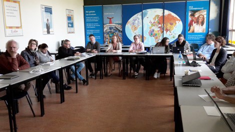 Teachers from both universities meeting in a classroom to discuss collaboration