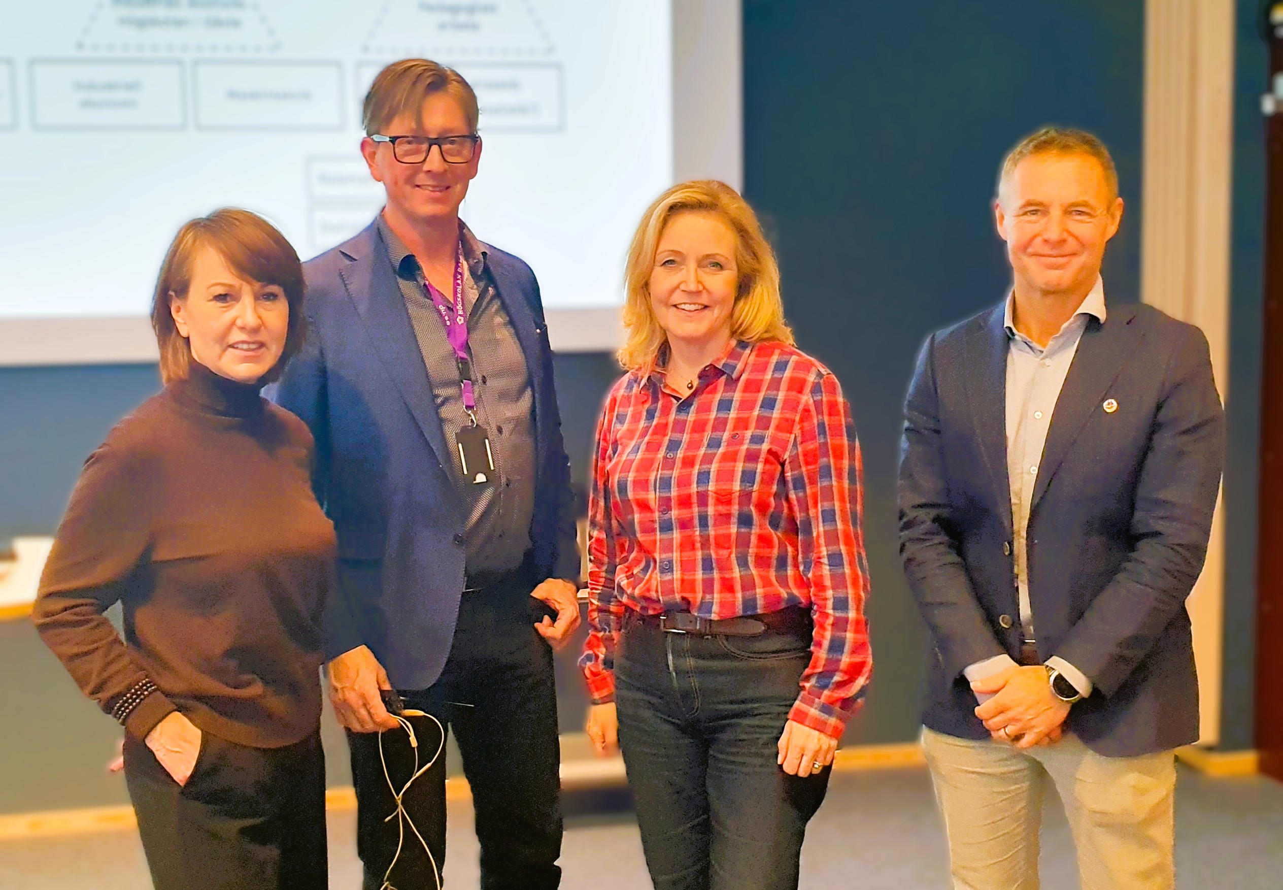 Group photo in front of a screen