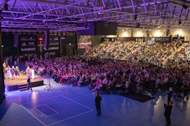 Big gathering at the Arena in Falun, many people sitting and watching the stage.