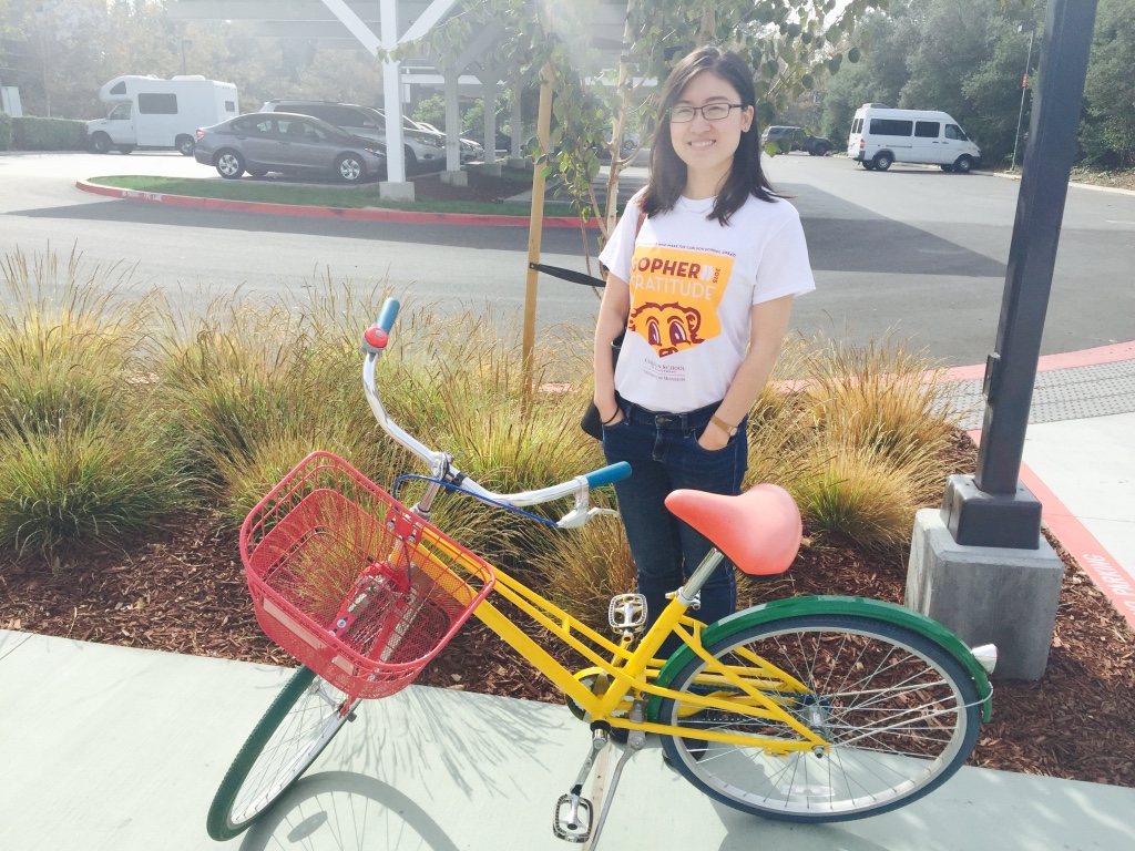 woman standing behind a bicycle